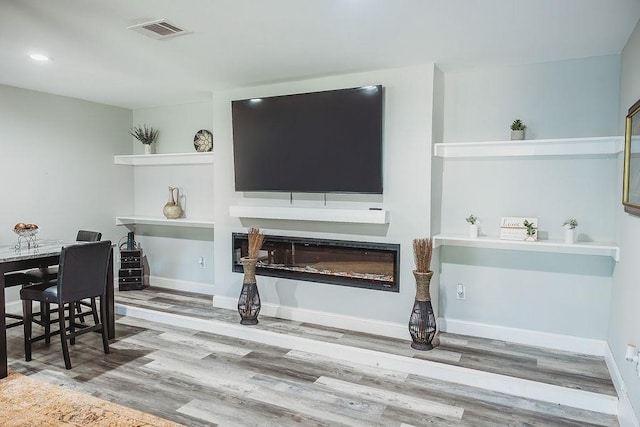 1313 E Turley St, Sherman, TX 75090 - dining space featuring wood finished floors, a glass covered fireplace, baseboards, and recessed lighting