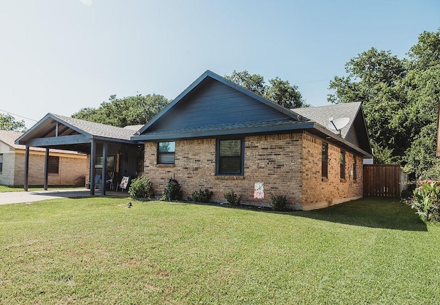 1313 E Turley St, Sherman, TX 75090 - view of side of home with an attached carport, brick siding, and driveway