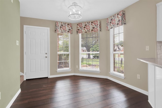 2103 Greenbrier St, Denison, TX 75020 - unfurnished dining area with plenty of natural light, a chandelier, wood-type flooring, and baseboards