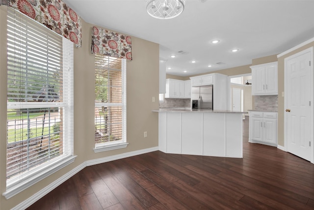 2103 Greenbrier St, Denison, TX 75020 - kitchen featuring stainless steel fridge with ice dispenser, tasteful backsplash, dark wood-style floors, light countertops, and a peninsula