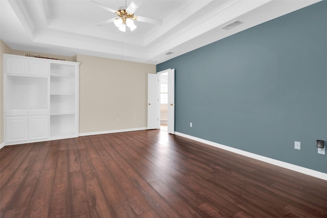 2103 Greenbrier St, Denison, TX 75020 - unfurnished bedroom with a tray ceiling, dark wood finished floors, crown molding, baseboards, and ceiling fan