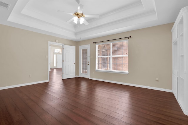 2103 Greenbrier St, Denison, TX 75020 - unfurnished bedroom featuring a tray ceiling, dark wood-type flooring, baseboards, ceiling fan, and ornamental molding