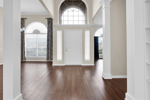 2103 Greenbrier St, Denison, TX 75020 - foyer featuring ornate columns, dark wood-type flooring, baseboards, and ornamental molding