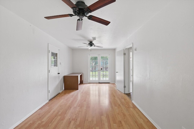 unfurnished room featuring a ceiling fan, baseboards, and light wood-style floors