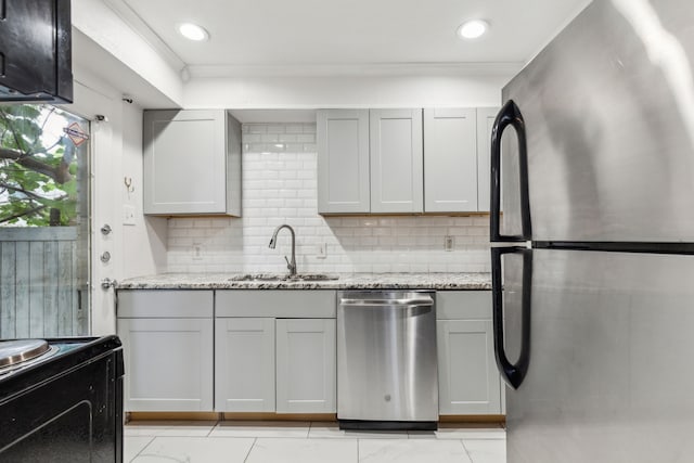 5033 N Hall St, Dallas, TX 75235 - kitchen with stainless steel appliances, a sink, tasteful backsplash, light stone counters, and ornamental molding