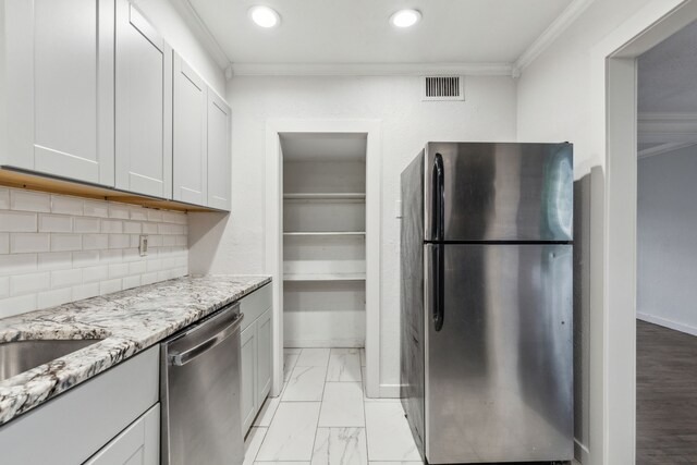5033 N Hall St, Dallas, TX 75235 - kitchen with stainless steel appliances, crown molding, light stone counters, decorative backsplash, and recessed lighting