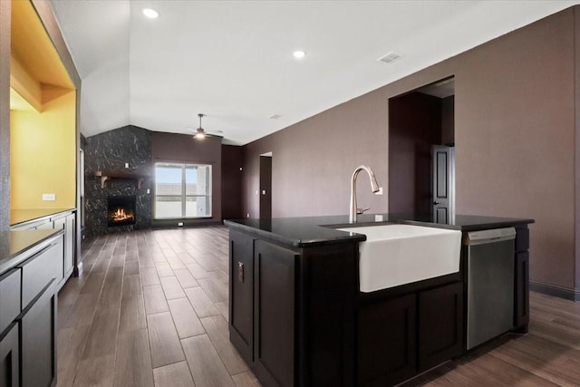 3005 Knoxbridge Rd, Forney, TX 75126 - kitchen featuring stainless steel dishwasher, a sink, vaulted ceiling, dark wood-type flooring, and dark countertops