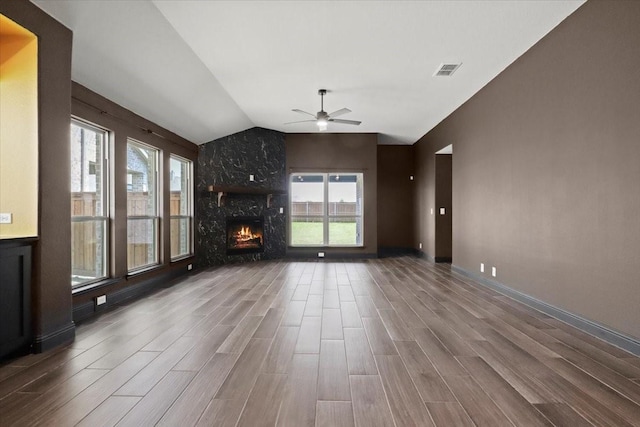3005 Knoxbridge Rd, Forney, TX 75126 - unfurnished living room featuring lofted ceiling, ceiling fan, plenty of natural light, wood finished floors, and a fireplace