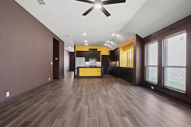 3005 Knoxbridge Rd, Forney, TX 75126 - kitchen featuring lofted ceiling, dark countertops, a ceiling fan, open floor plan, and dark wood-type flooring