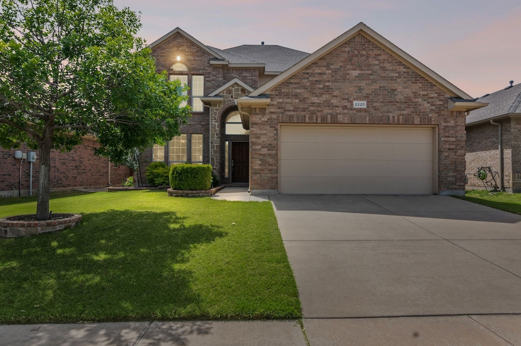 2220 Frosted Willow Ln, Fort Worth, TX 76177 - traditional-style home with an attached garage, driveway, a front lawn, and brick siding
