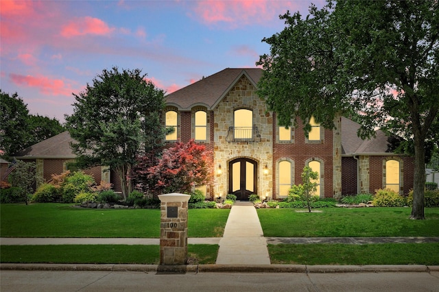 100 Country Club Dr, Heath, TX 75032 - french country inspired facade featuring a front yard, stone siding, brick siding, and french doors