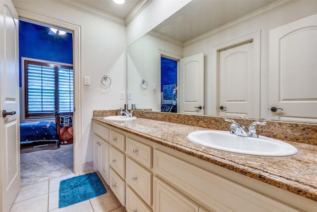 bathroom featuring tile patterned flooring, crown molding, double vanity, ensuite bathroom, and baseboards