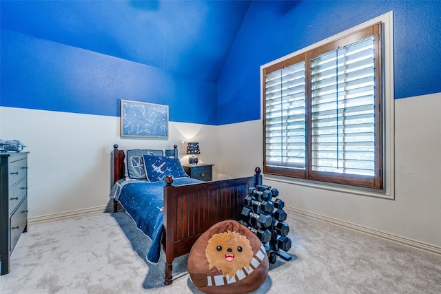 carpeted bedroom with lofted ceiling and baseboards
