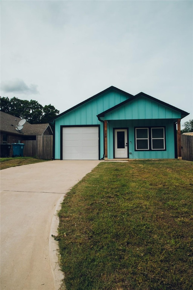 729 E Sears St, Denison, TX 75021 - view of front of house with concrete driveway, an attached garage, and board and batten siding