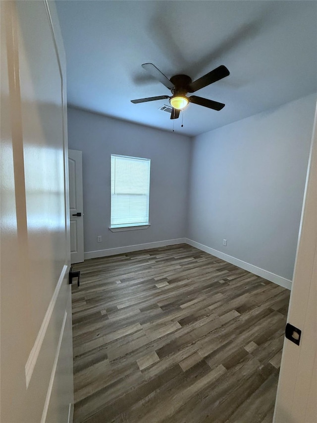 729 E Sears St, Denison, TX 75021 - empty room featuring a ceiling fan, dark wood-type flooring, and baseboards