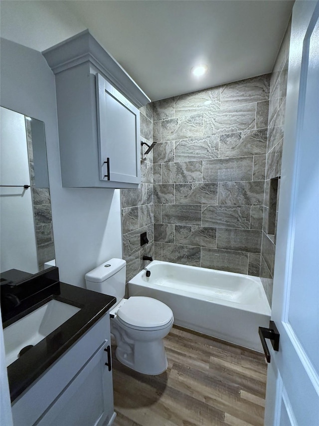 729 E Sears St, Denison, TX 75021 - bathroom featuring wood finished floors, vanity, bathtub / shower combination, toilet, and recessed lighting