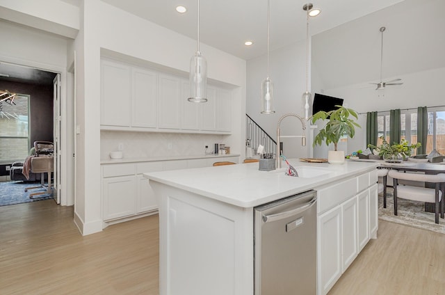 627 Brockwell Bnd, Forney, TX 75126 - kitchen featuring stainless steel dishwasher, light wood-style floors, white cabinets, light countertops, and pendant lighting
