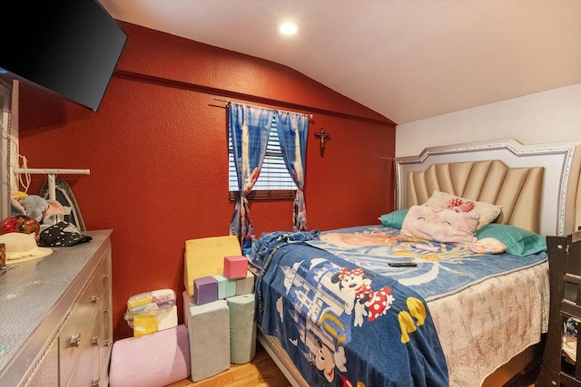 1017 S Newark Ave, Fort Worth, TX 76105 - bedroom featuring vaulted ceiling, a textured wall, and wood finished floors