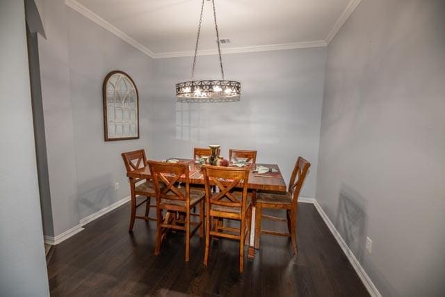 107 Harvest Way, Crandall, TX 75114 - dining room with wood finished floors, baseboards, crown molding, and a chandelier