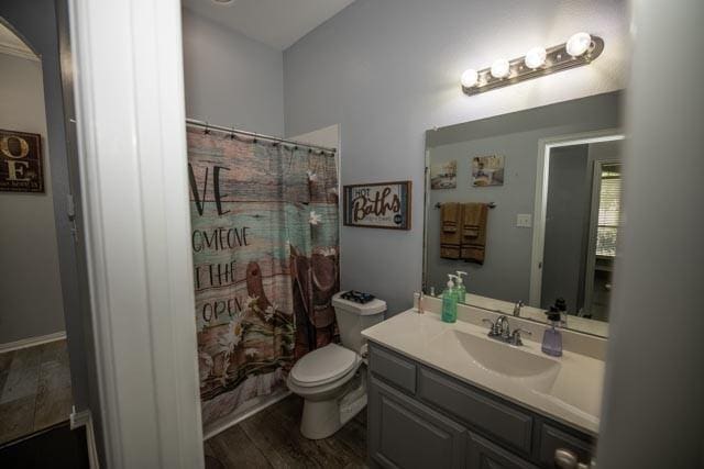 107 Harvest Way, Crandall, TX 75114 - full bathroom featuring vanity, toilet, wood finished floors, and a shower with shower curtain