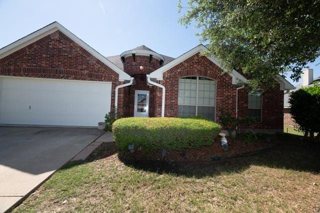 107 Harvest Way, Crandall, TX 75114 - view of front of home featuring brick siding, a garage, driveway, and a front lawn