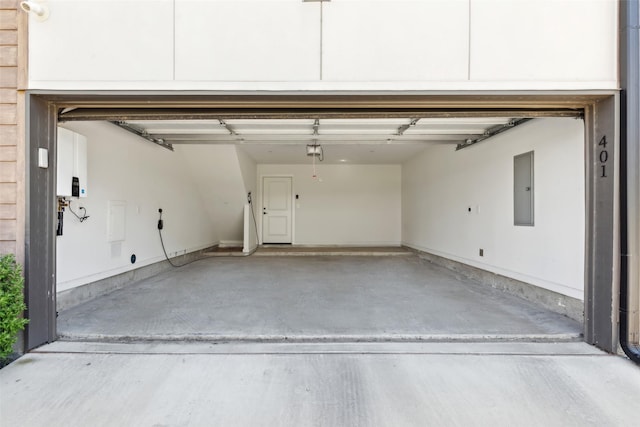 13900 Noel Rd Unit 401, Dallas, TX 75240 - garage featuring electric panel and a garage door opener