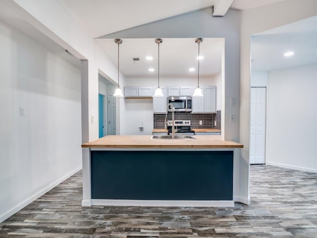 3906 Westview Dr, Rowlett, TX 75088 - kitchen with wooden counters, appliances with stainless steel finishes, dark wood finished floors, backsplash, and a sink