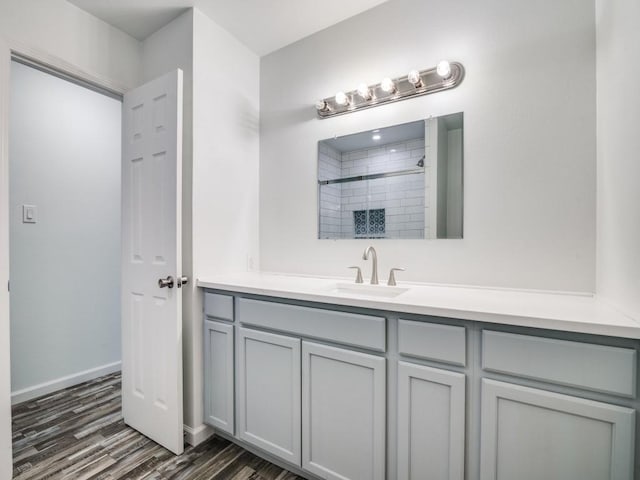 3906 Westview Dr, Rowlett, TX 75088 - full bathroom featuring vanity, wood finished floors, tiled shower, and baseboards