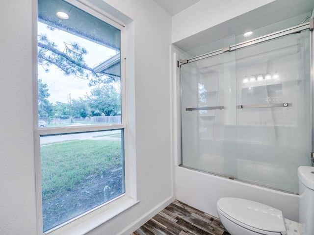 3906 Westview Dr, Rowlett, TX 75088 - bathroom with toilet, bath / shower combo with glass door, and wood finished floors
