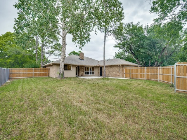 3906 Westview Dr, Rowlett, TX 75088 - back of property with a chimney, a patio, and brick siding