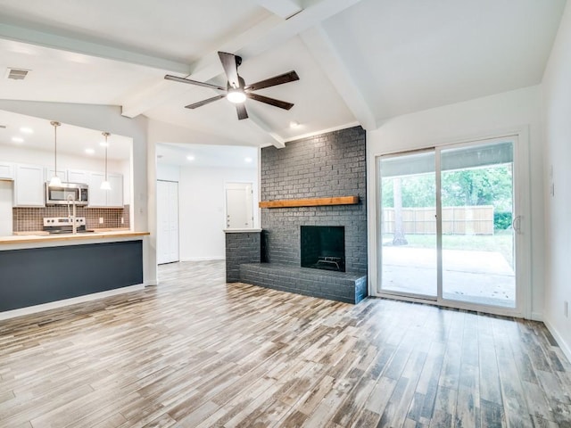 3906 Westview Dr, Rowlett, TX 75088 - unfurnished living room featuring ceiling fan, light wood finished floors, a fireplace, baseboards, and recessed lighting