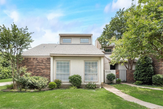 13156 Burninglog Ln, Dallas, TX 75243 - view of front facade featuring a front lawn, roof with shingles, brick siding, and stucco siding