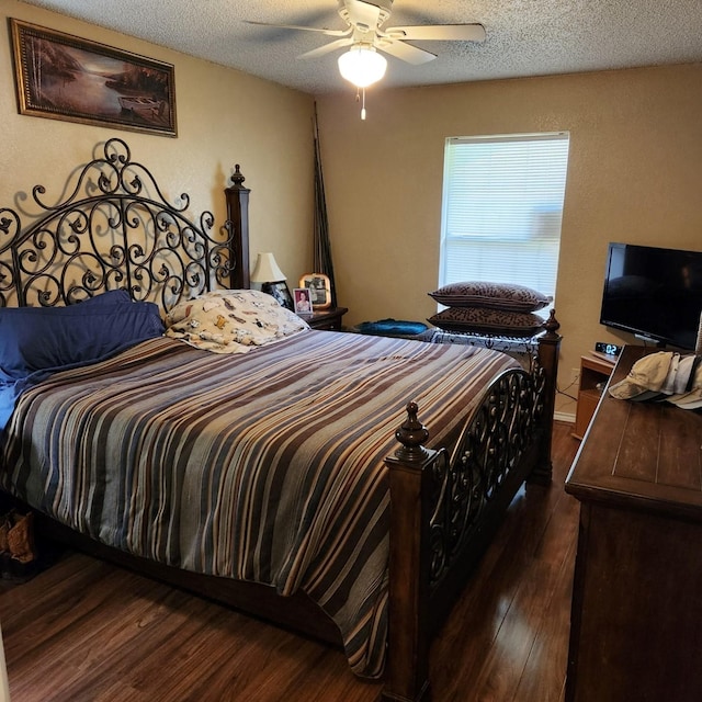 611 N Lamar St, Tioga, TX 76271 - bedroom with dark wood-style floors, a textured ceiling, and ceiling fan