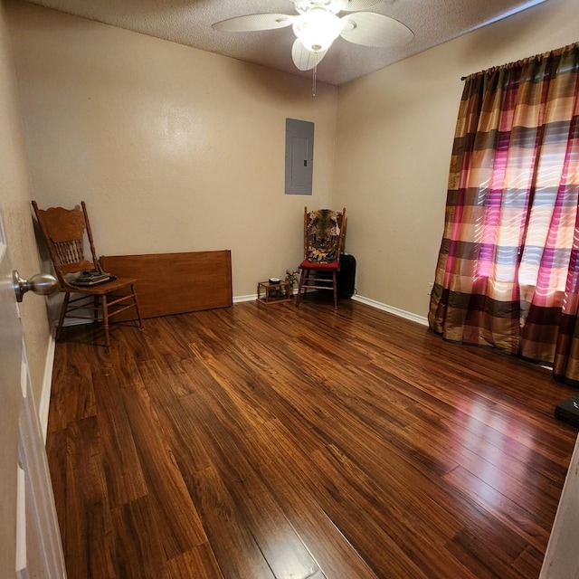 611 N Lamar St, Tioga, TX 76271 - spare room with electric panel, wood finished floors, ceiling fan, baseboards, and a textured ceiling