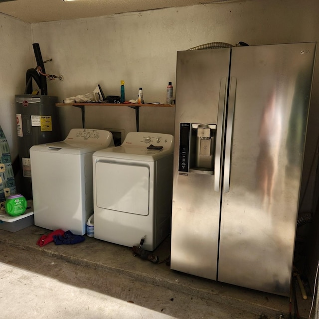 611 N Lamar St, Tioga, TX 76271 - washroom featuring washing machine and clothes dryer and electric water heater