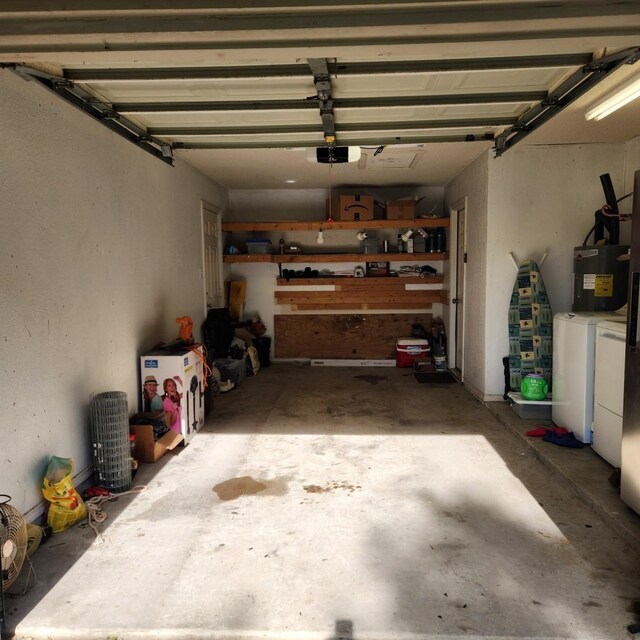611 N Lamar St, Tioga, TX 76271 - garage featuring independent washer and dryer, water heater, and a garage door opener