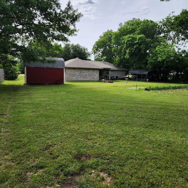 611 N Lamar St, Tioga, TX 76271 - view of green lawn with a storage unit, an outbuilding, and a detached carport