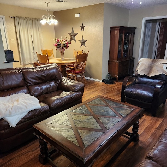 611 N Lamar St, Tioga, TX 76271 - living area featuring wood finished floors, a chandelier, and baseboards