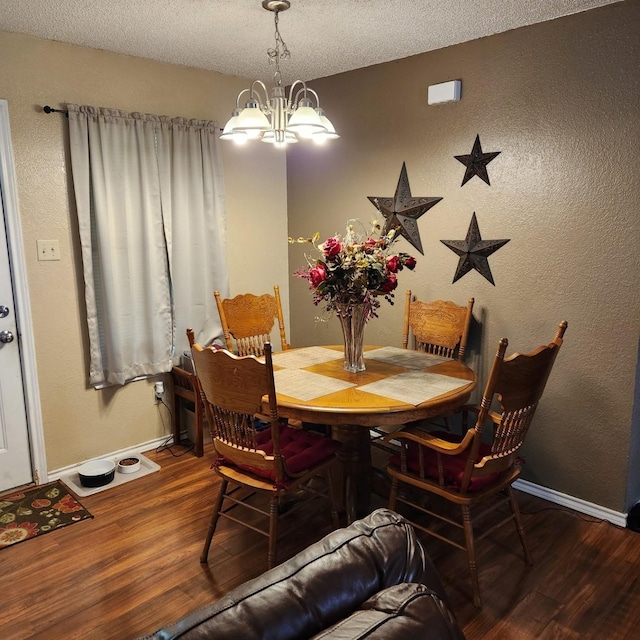 611 N Lamar St, Tioga, TX 76271 - dining space featuring wood finished floors, a chandelier, baseboards, and a textured ceiling