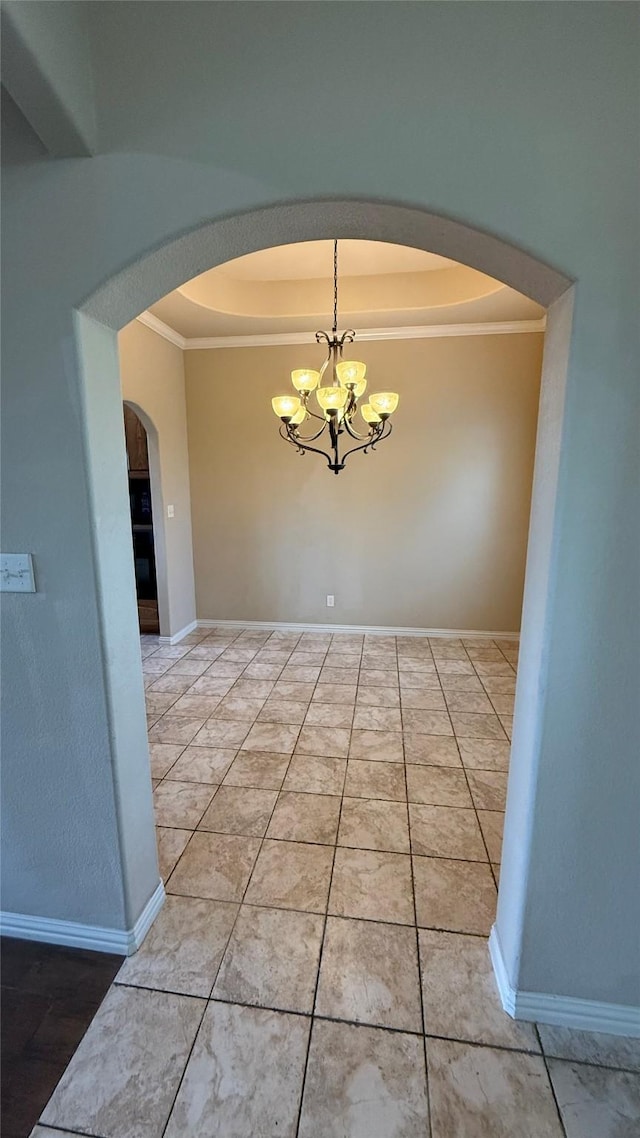 124 Heritage Pkwy W, Decatur, TX 76234 - spare room featuring a tray ceiling, arched walkways, a chandelier, ornamental molding, and baseboards
