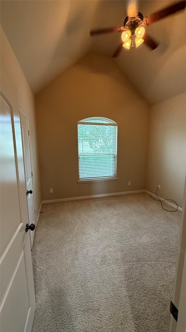 124 Heritage Pkwy W, Decatur, TX 76234 - spare room featuring light colored carpet, vaulted ceiling, a ceiling fan, and baseboards