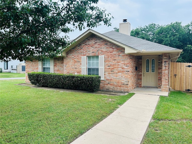 601 Lawrence Ave, Terrell, TX 75160 - ranch-style house with brick siding, a chimney, and a shingled roof
