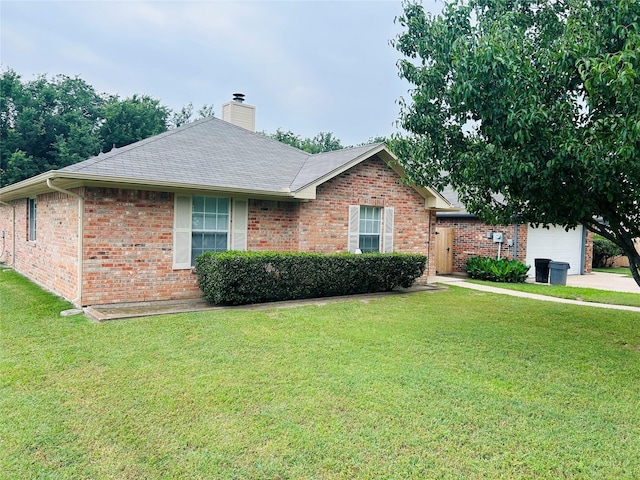 601 Lawrence Ave, Terrell, TX 75160 - single story home with brick siding, a front lawn, and a chimney