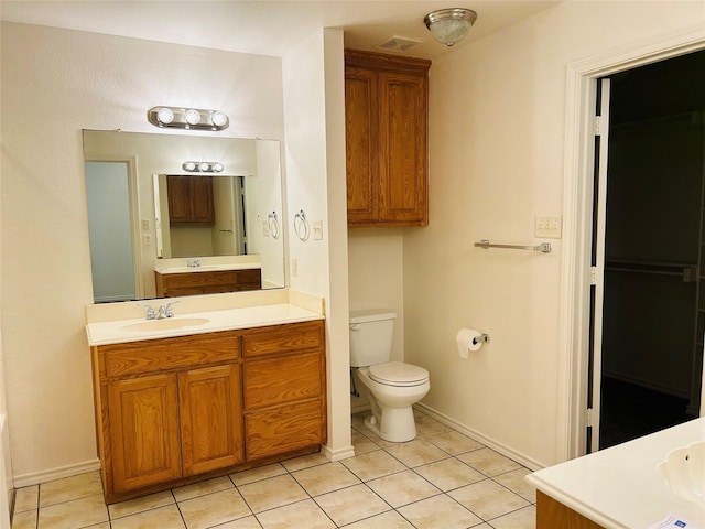 601 Lawrence Ave, Terrell, TX 75160 - bathroom with tile patterned flooring, vanity, toilet, and baseboards