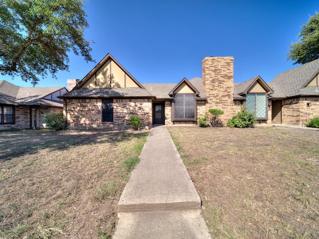 3920 Saint Christopher Ln, Dallas, TX 75287 - view of front of home with a front yard and a chimney