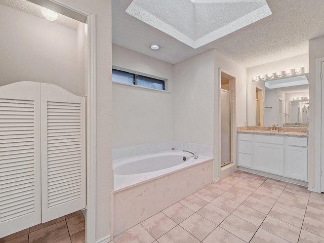 3920 Saint Christopher Ln, Dallas, TX 75287 - bathroom featuring a stall shower, tile patterned floors, vanity, a textured ceiling, and a bath