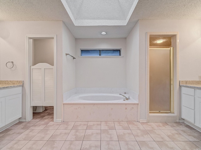 3920 Saint Christopher Ln, Dallas, TX 75287 - bathroom featuring a textured ceiling, vanity, a shower stall, tile patterned flooring, and a garden tub