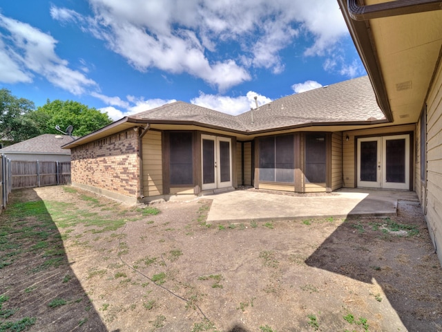 3920 Saint Christopher Ln, Dallas, TX 75287 - back of property featuring french doors, a patio area, a fenced backyard, brick siding, and roof with shingles