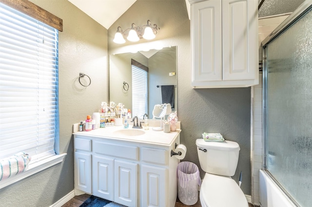 2113 Old Foundry Rd, Weatherford, TX 76087 - bathroom featuring plenty of natural light, vaulted ceiling, a textured wall, vanity, and toilet