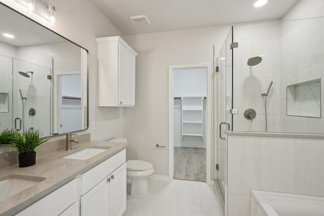 12350 Orloff Dr, Rhome, TX 76078 - full bath with a shower stall, a walk in closet, double vanity, toilet, and recessed lighting